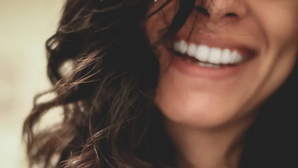 Woman smiling after a dental bridge treatment