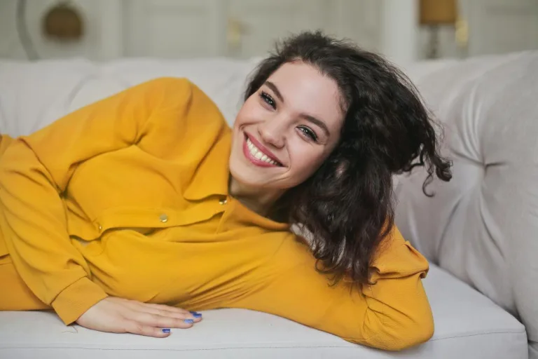 Girl in yellow shirt on sofa